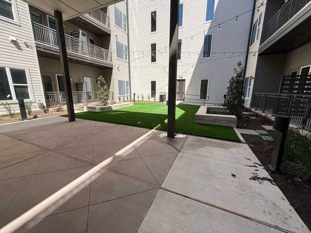 Commercial courtyard with synthetic turf and concrete - LongHorn Landscape commercial project